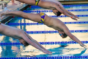 Calvin Rhoads, center, won the 100 Butterfly in last week's dual meet against Golden West.
